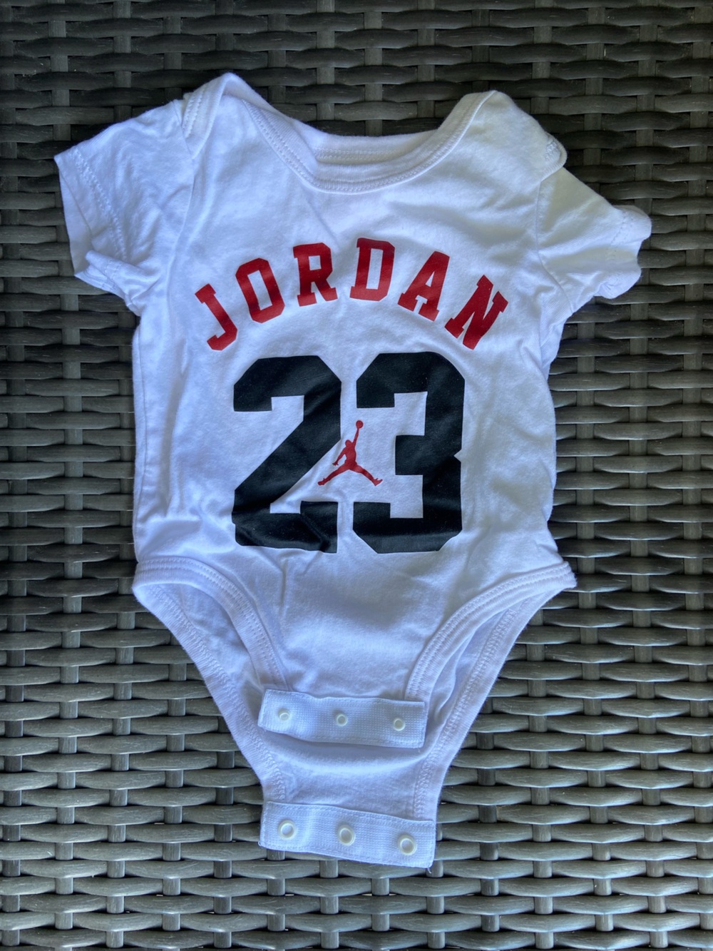 Jordan White Baby Onesie with Black and Red Graphics